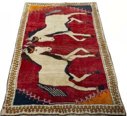 Surface texture of 2000s Persian Gabbeh rug with natural Wool and intricate pattern