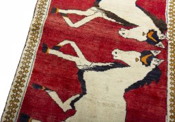 Backside of handmade 2000s Persian Gabbeh rug showing knot structure and weave density