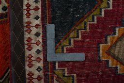 Corner detail of 2000s Persian Gabbeh rug showing border pattern and Wool pile