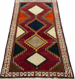 Surface texture of 2000s Persian Gabbeh rug with natural Wool and intricate pattern
