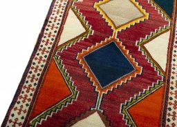 Backside of handmade 2000s Persian Gabbeh rug showing knot structure and weave density
