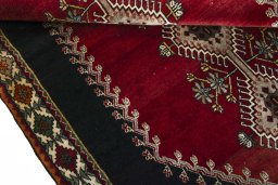 Corner detail of 2000s Persian Gabbeh rug showing border pattern and Wool pile