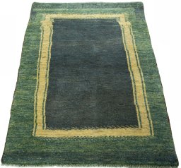 Surface texture of 2000s Persian Gabbeh rug with natural Wool and intricate pattern