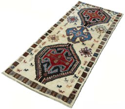 Corner detail of 2000s Persian Gabbeh rug showing border pattern and Wool pile