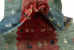 Corner detail of 1970s Persian Gabbeh rug showing border pattern and Wool pile