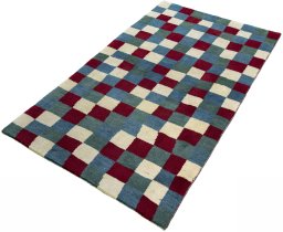 Corner detail of 2000s Persian Gabbeh rug showing border pattern and Wool pile