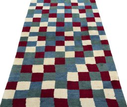 Surface texture of 2000s Persian Gabbeh rug with natural Wool and intricate pattern
