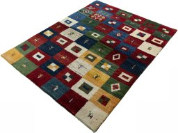 Corner detail of 2000s Persian Gabbeh rug showing border pattern and Wool pile