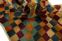 Corner detail of 2000s Persian Gabbeh rug showing border pattern and Wool pile