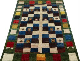 Surface texture of 2000s Persian Gabbeh rug with natural Wool and intricate pattern