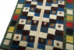 Backside of handmade 2000s Persian Gabbeh rug showing knot structure and weave density