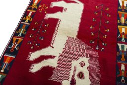 Backside of handmade 2000s Persian Gabbeh rug showing knot structure and weave density