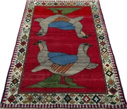 Surface texture of 2000s Persian Gabbeh rug with natural Wool and intricate pattern
