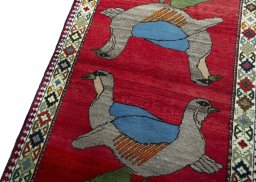 Backside of handmade 2000s Persian Gabbeh rug showing knot structure and weave density