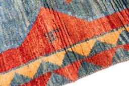 Backside of handmade 1975s Persian Gabbeh rug showing knot structure and weave density
