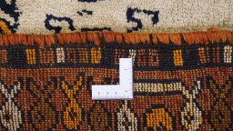 Corner detail of 2000s Persian Gabbeh rug showing border pattern and Wool pile