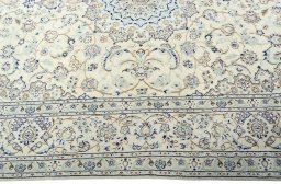 Corner detail of 2000s Nain rug showing border pattern and Wool pile