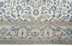 Corner detail of 2000s Kashan rug showing border pattern and Wool pile