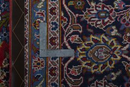 Backside of handmade New Kashan rug showing knot structure and weave density