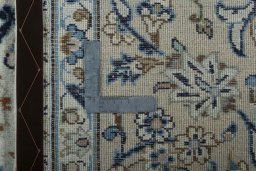 Backside of handmade 2000s Kashan rug showing knot structure and weave density