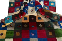 Corner detail of 2000s Persian Gabbeh rug showing border pattern and Wool pile