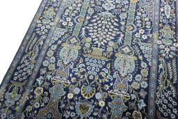 Backside of handmade 2000s Kashan rug showing knot structure and weave density