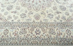 Corner detail of 2000s Nain rug showing border pattern and Wool pile