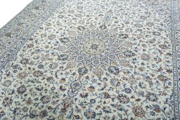 Backside of handmade 2000s Kashan rug showing knot structure and weave density