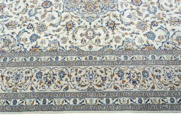 Corner detail of 2000s Kashan rug showing border pattern and Wool pile