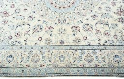 Corner detail of 2000s Nain rug showing border pattern and Wool pile