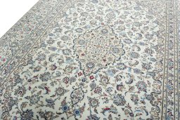 Backside of handmade 2000s Kashan rug showing knot structure and weave density