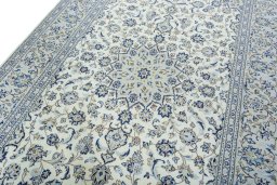 Backside of handmade 2000s Kashan rug showing knot structure and weave density