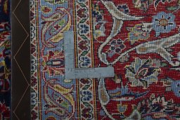 Backside of handmade New Kashan rug showing knot structure and weave density