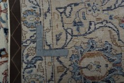 Backside of handmade 2000s Kashan rug showing knot structure and weave density