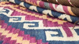 Close-up detail of New Kilim Traditional rug from Iran / Persia showing Wool weave
