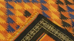 Close-up detail of New Kilim Traditional rug from Iran / Persia showing Wool weave