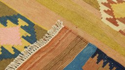 Close-up detail of New Kilim Traditional rug from Iran / Persia showing Wool weave