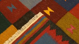 Close-up detail of New Kilim Traditional rug from Iran / Persia showing Wool weave