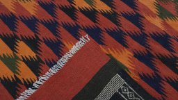 Close-up detail of New Kilim Traditional rug from Iran / Persia showing Wool weave