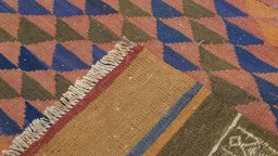 Close-up detail of New Kilim Traditional rug from Iran / Persia showing Wool weave