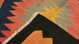 Close-up detail of New Kilim Traditional rug from Iran / Persia showing Wool weave