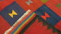 Close-up detail of New Kilim Traditional rug from Iran / Persia showing Wool weave