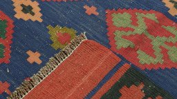 Close-up detail of New Kilim Traditional rug from Iran / Persia showing Wool weave