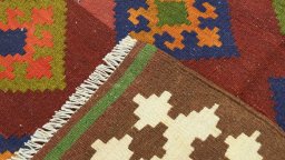 Close-up detail of New Kilim Traditional rug from Iran / Persia showing Wool weave
