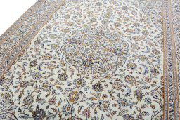 Backside of handmade 2000s Kashan rug showing knot structure and weave density