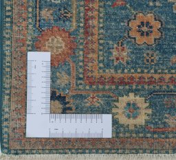 Corner detail of New Kazak rug showing border pattern and Wool pile