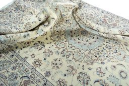 Surface texture of 2000s Nain rug with natural Wool and intricate pattern