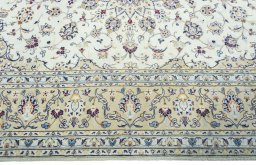 Corner detail of 2000s Kashan rug showing border pattern and Wool pile
