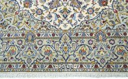 Corner detail of 2000s Kashan rug showing border pattern and Cork pile