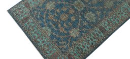 Backside of handmade New Farahan rug showing knot structure and weave density